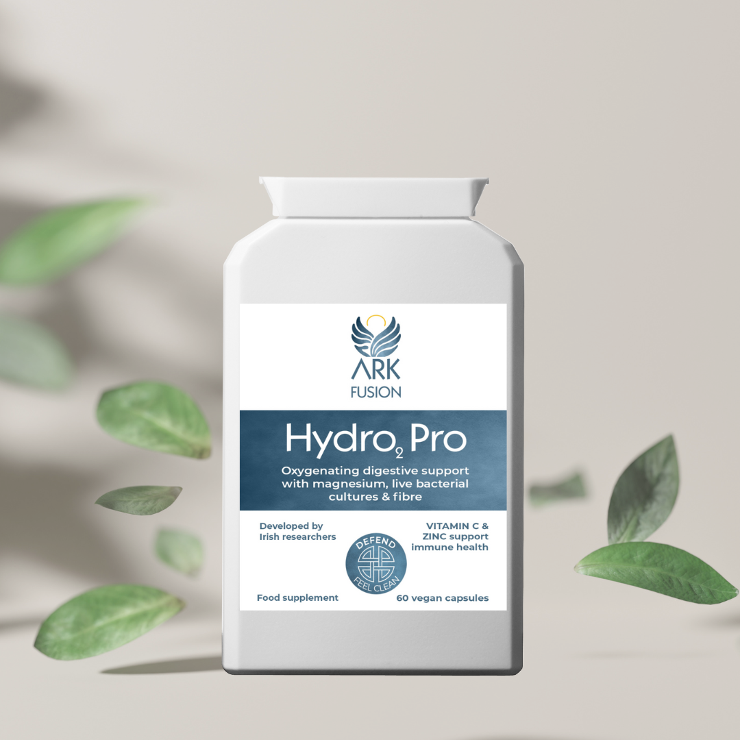 Visual of Hydro₂ Pro product amid floating green leaves on a minimal beige background, evoking detoxification and digestive wellness.